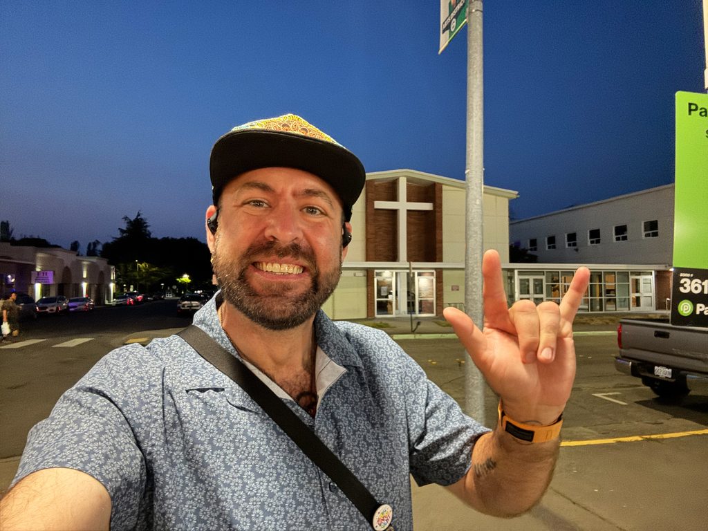 I_Am_Getting_Married_v1.zip 6 Selfie of Tukayote flashing the ASL I love you sign on a street at dusk