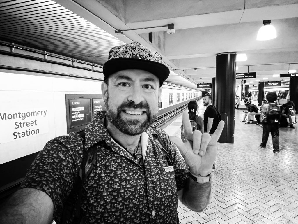 Black and white selfie of Tukayote on the platform at Montgomery Street Station