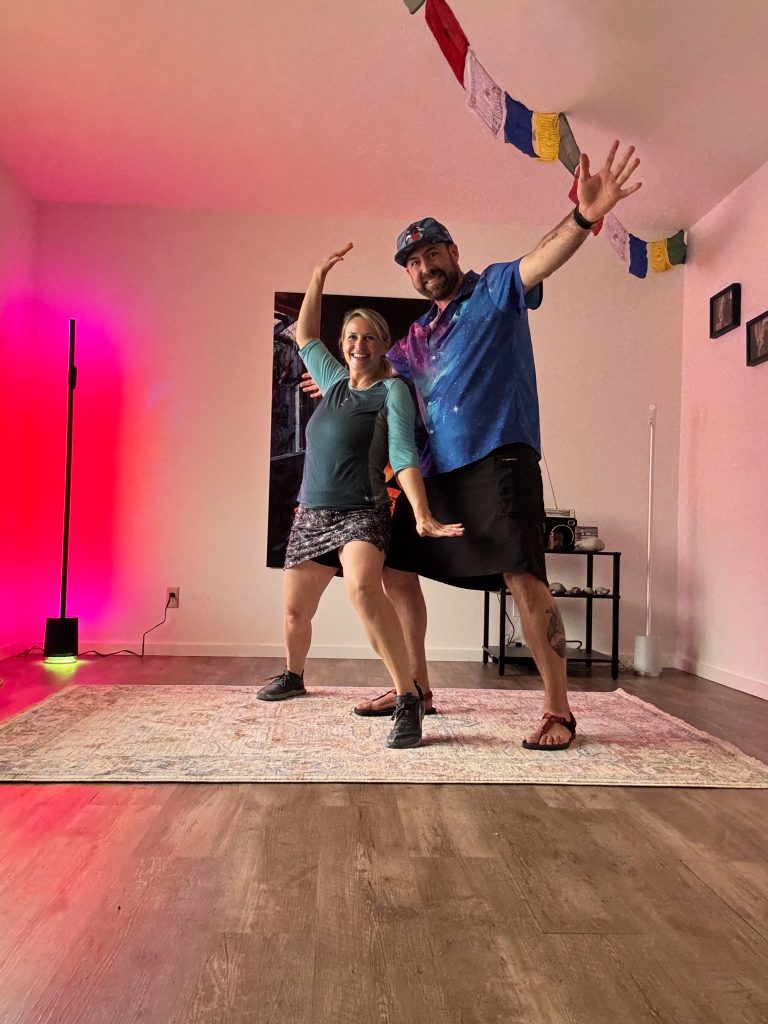 I_Am_Getting_Married_v1.zip 2 Tukayote and a friend posing playfully in a room lit pink with prayer flags overhead